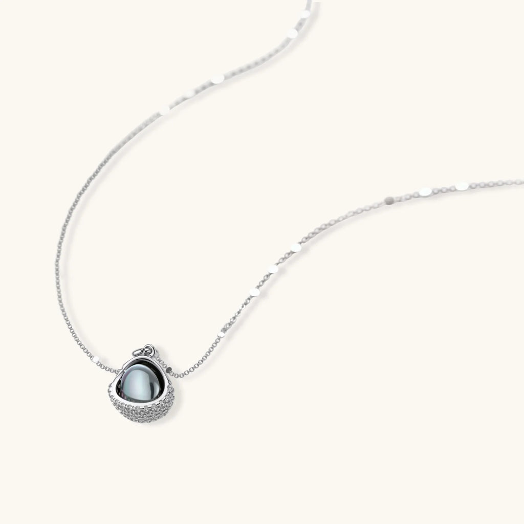 Necklace and stud earrings set with silver-gray domed centers in white gold plated eco-brass shells pavé-set with zirconia.