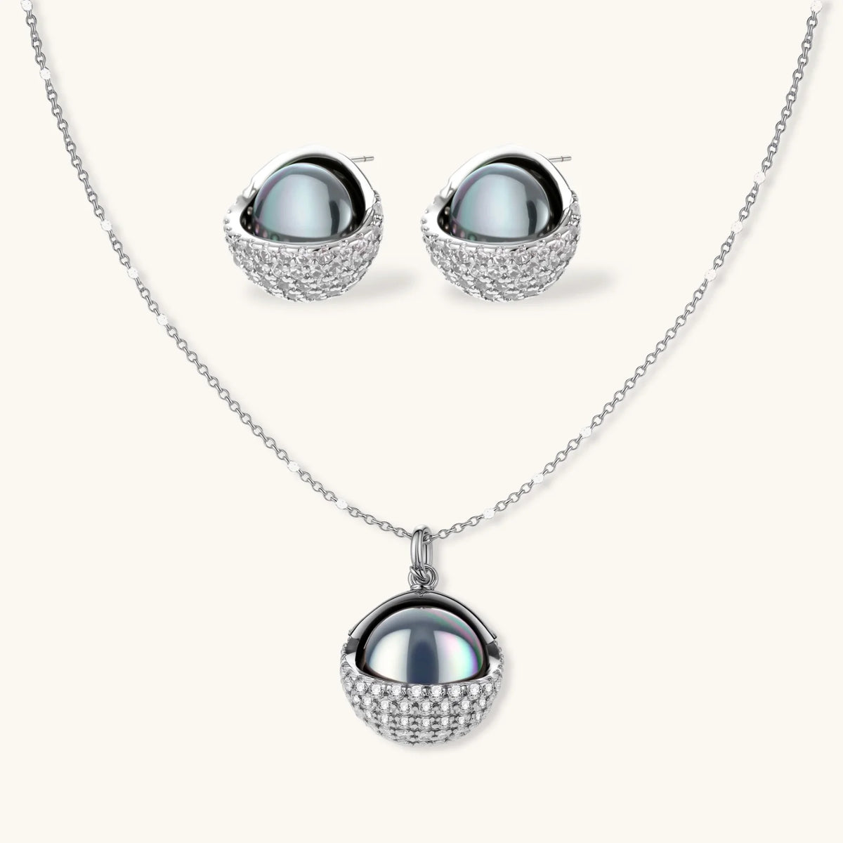 Necklace and stud earrings set with silver-gray domed centers in white gold plated eco-brass shells pavé-set with zirconia.
