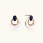 Gold plated stud earrings with an oval lapis lazuli top, CZ-lined teardrop loop and white MOP crescent on a cream background.