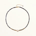 Dainty necklace with faceted purple iolite beads, gold vermeil accents, and central pink-white freshwater pearl.