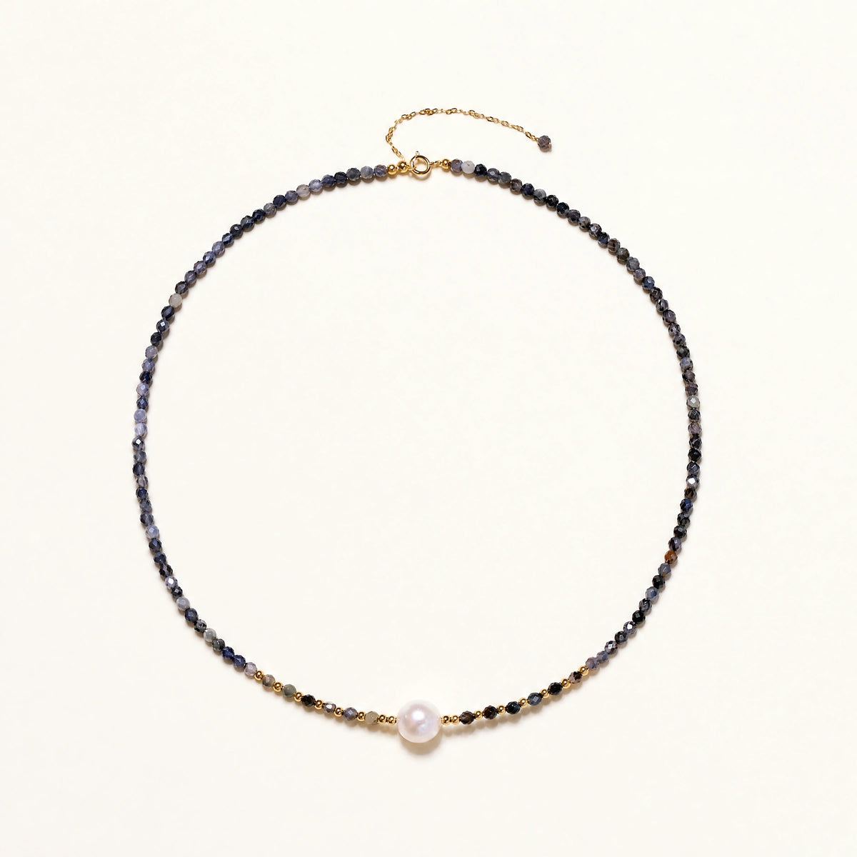 Dainty necklace with faceted purple iolite beads, gold vermeil accents, and central pink-white freshwater pearl.