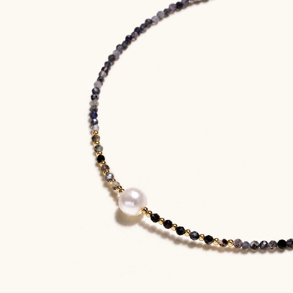 Dainty necklace with faceted purple iolite beads, gold vermeil accents, and central pink-white freshwater pearl.