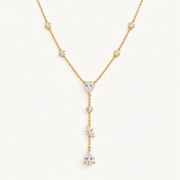 Collier Aube – collier en Y doré à cristaux sur fond blanc cassé, N.A. Paris